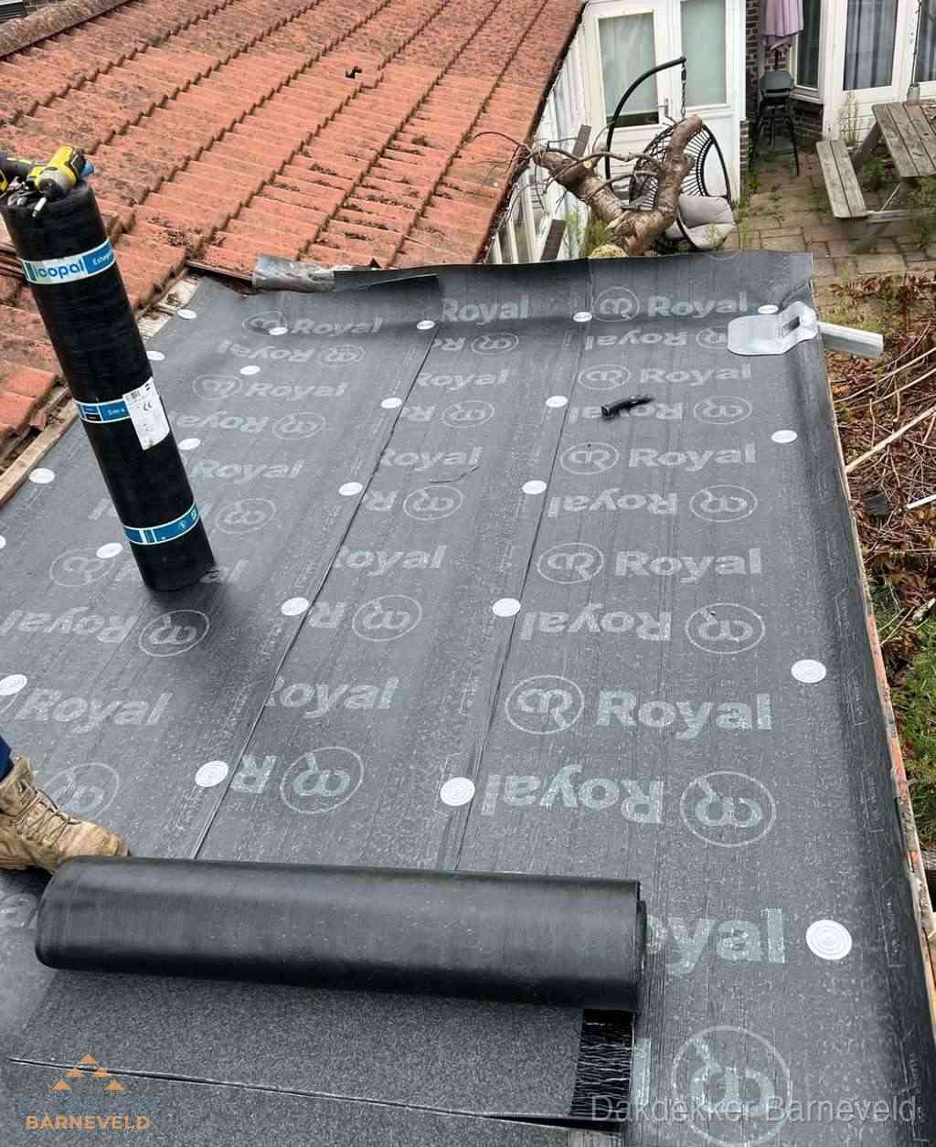Plat dak met nieuwe bitumen dakbedekking en brandgereedschap in Barneveld